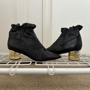 Black ankle boots with gold heel